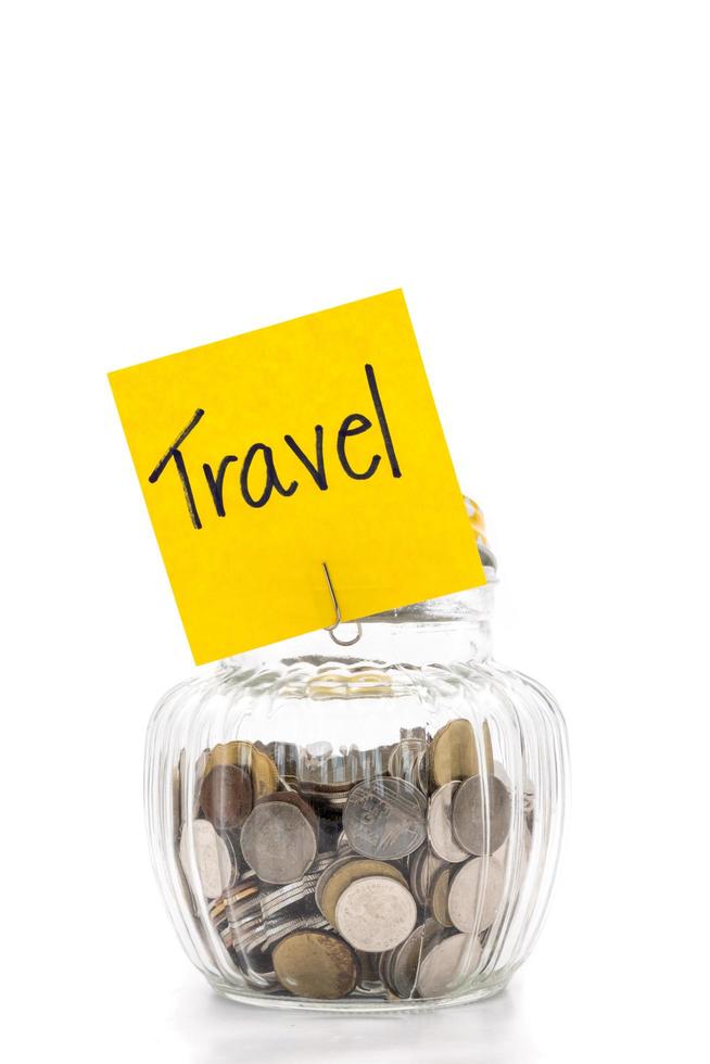 Coins in glass bottle on white background, saving money for Travel photo