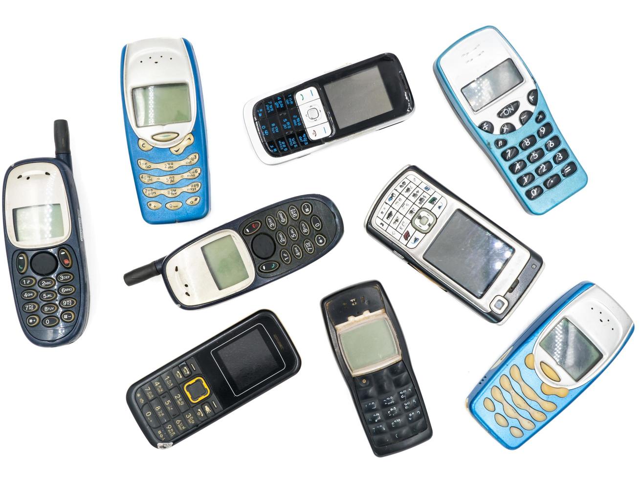 Top view of Old mobile phones on white background photo