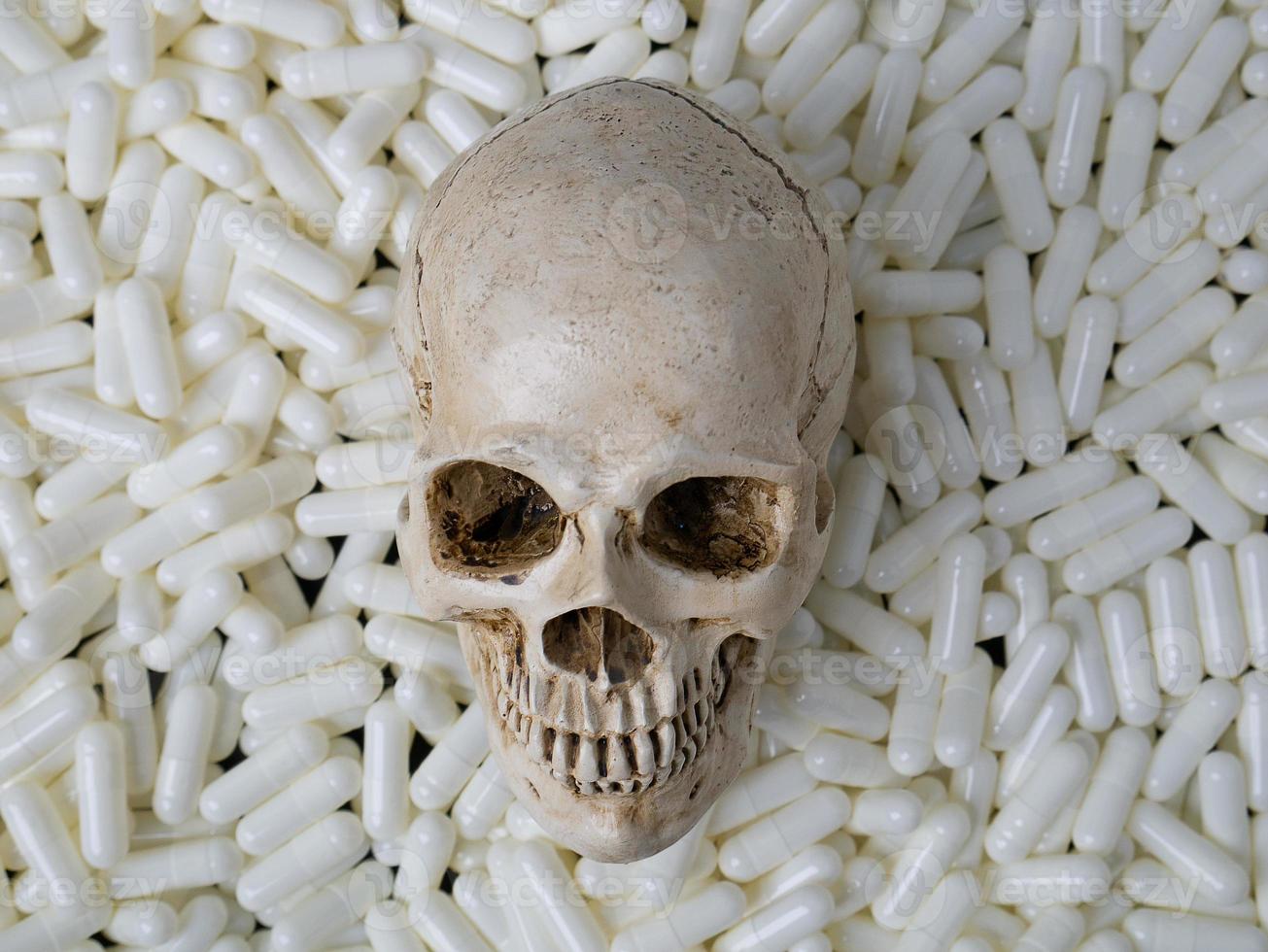 The skull  and white capsules image  for  sci or medical content. photo