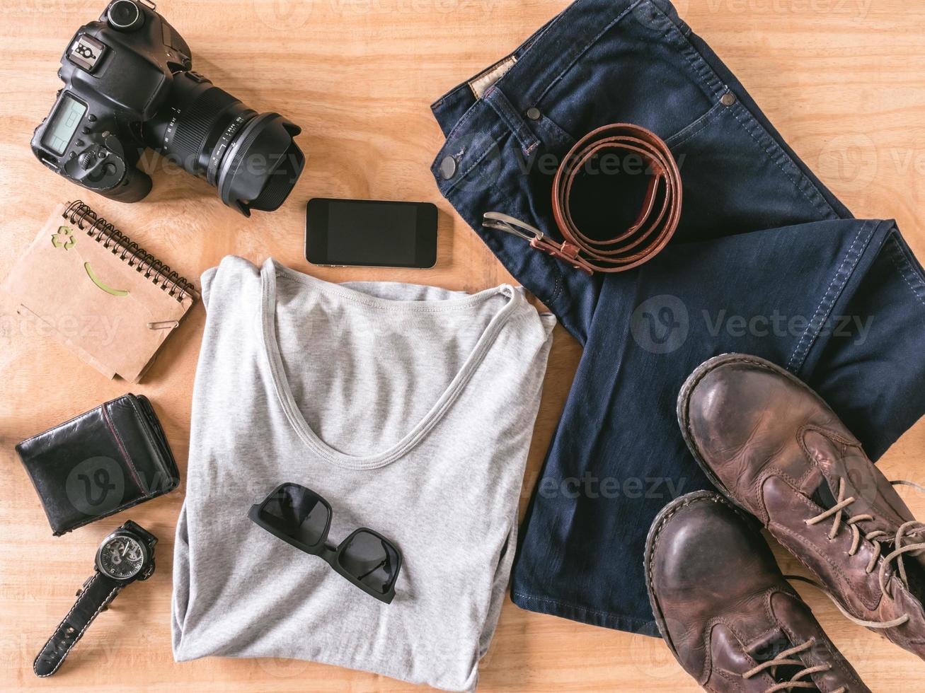 Top view of Men's casual outfits with accessories on wooden table background photo