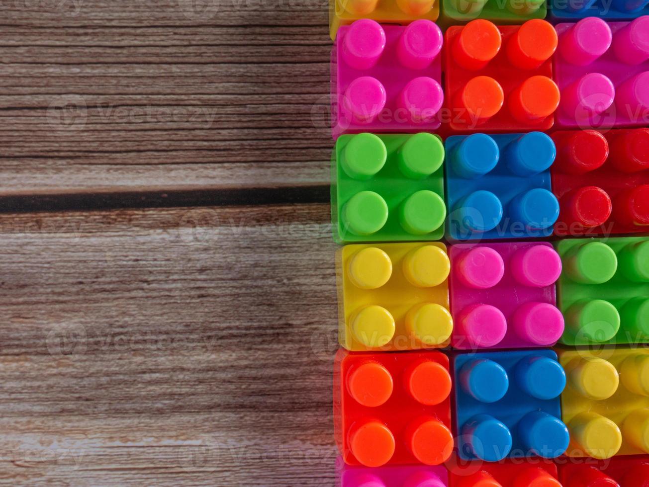 Toy brick on wood table photo