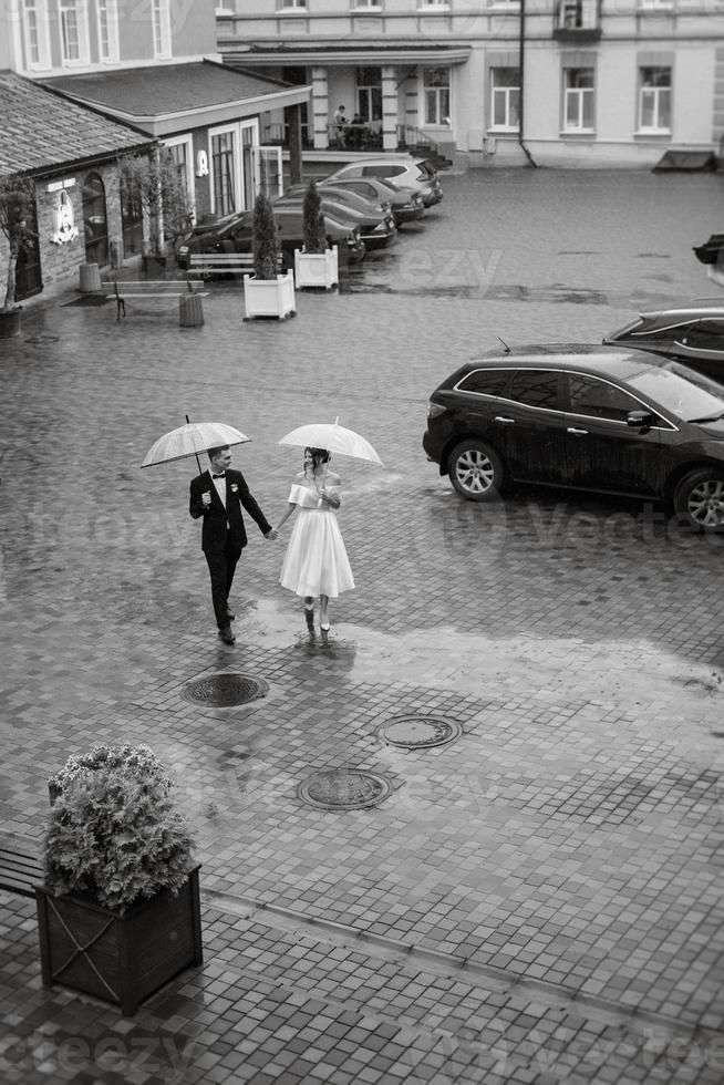 young couple bride and groom in a white short dress photo