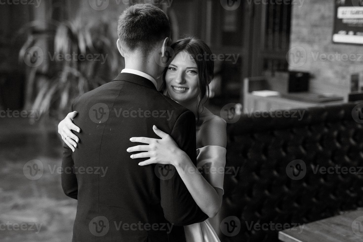 young couple bride and groom in a white short dress photo