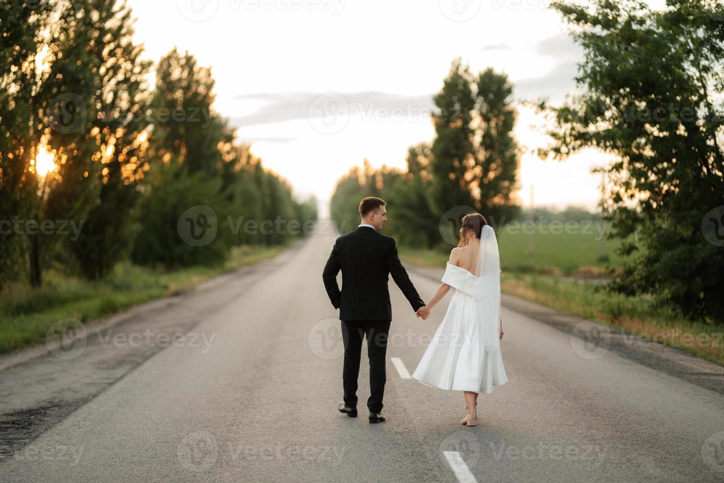 young couple bride and groom in a white short dress photo