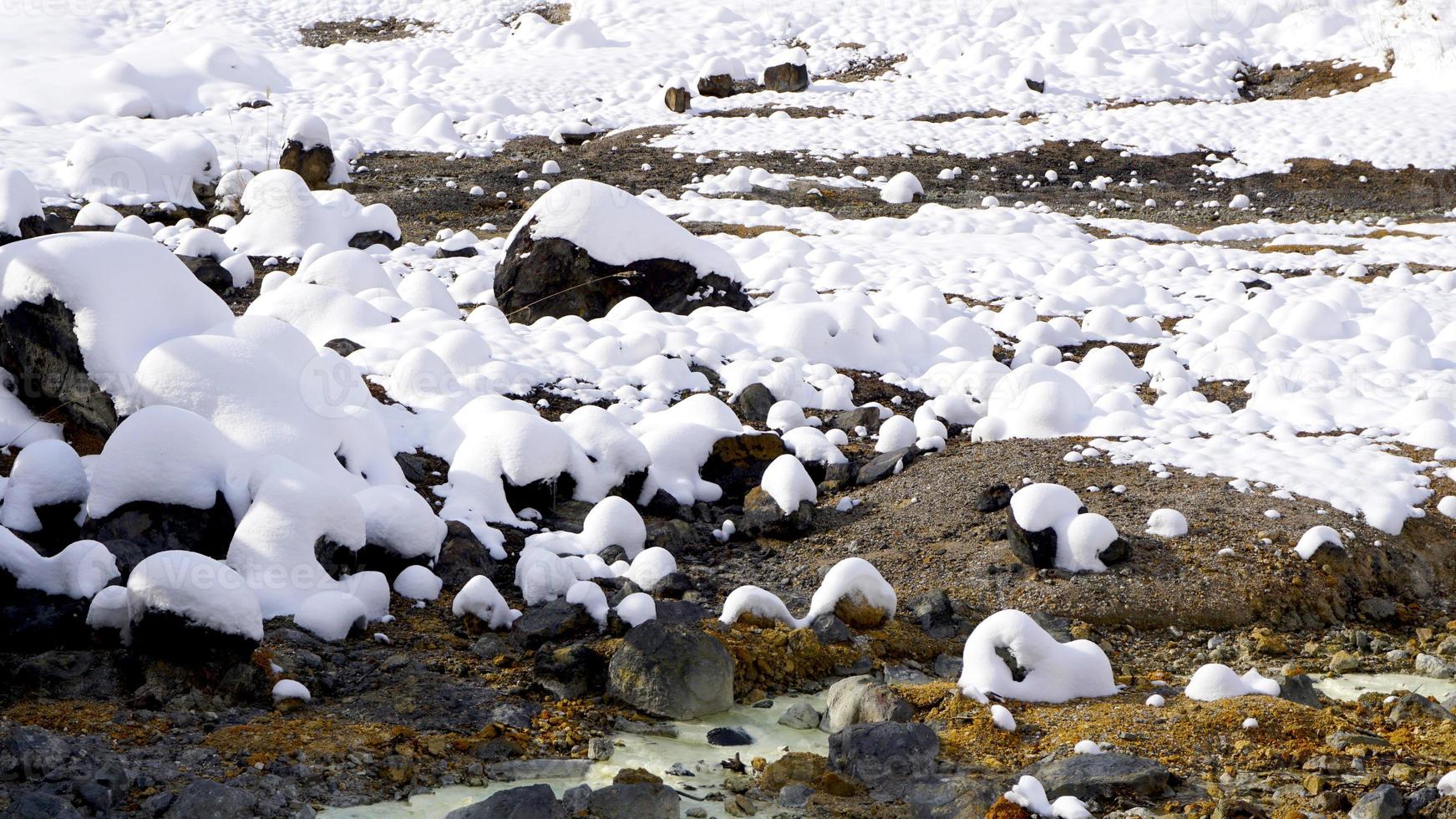 Closeup stone and snow in the mist Noboribetsu onsen photo