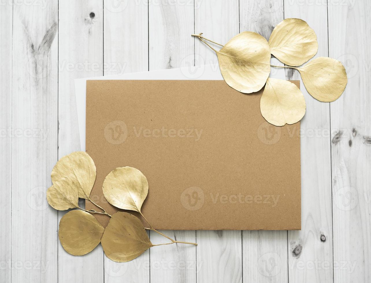 Mockup for a letter or a wedding invitation with gold leaves eucalyptus branches. photo