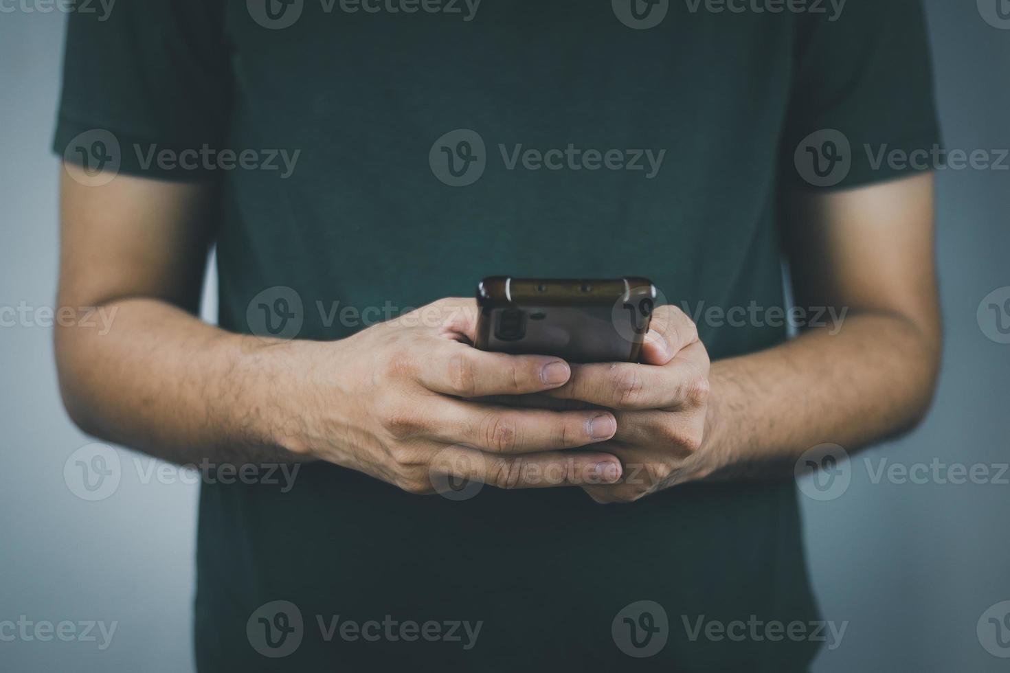 Social media technology concept, men's hands using smartphones to login social media, work from home or do online marketing. business and finance photo