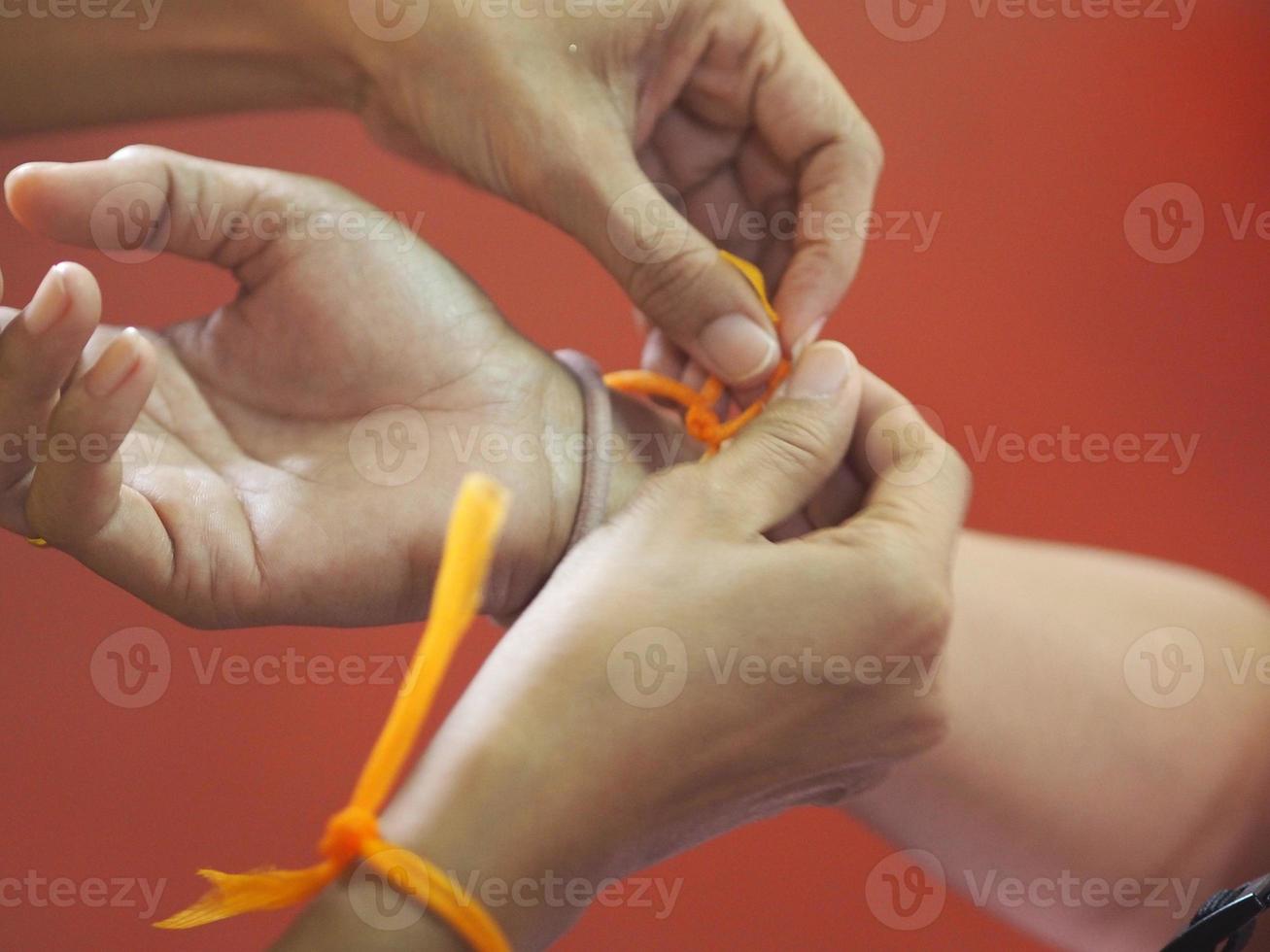 tie a string on the wrist photo