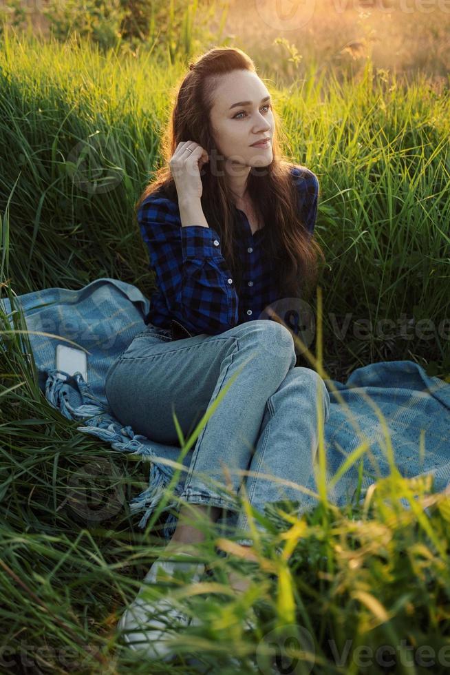 Portrait of a beautiful young woman on meadow photo