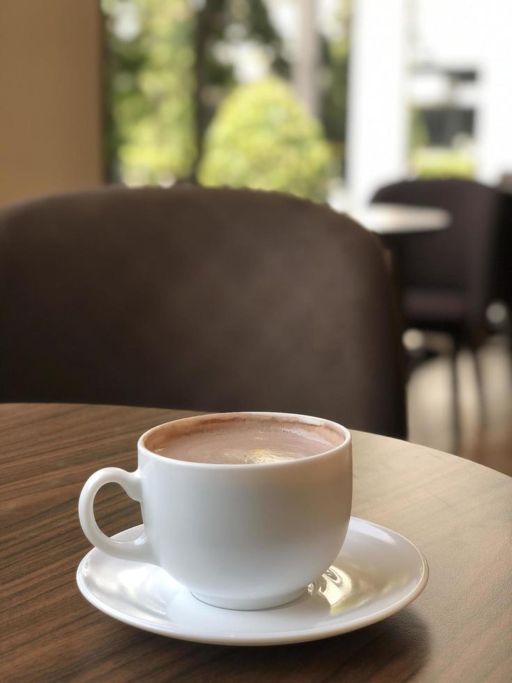 Hot coffee cup on table photo