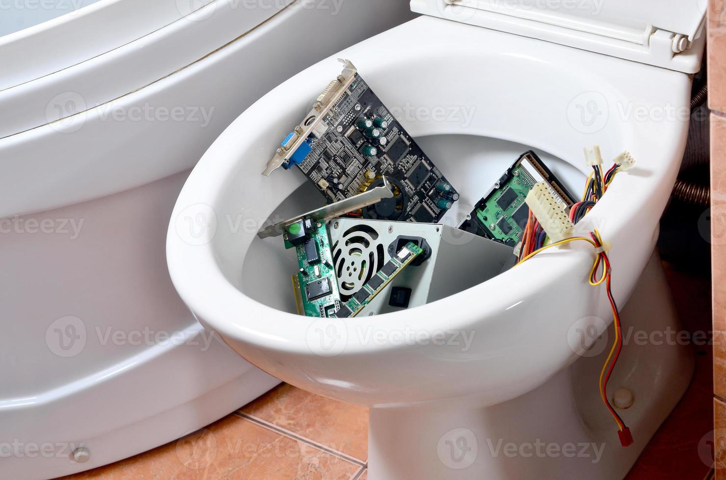 Old and unused computer details is recycled in toilet bowl photo