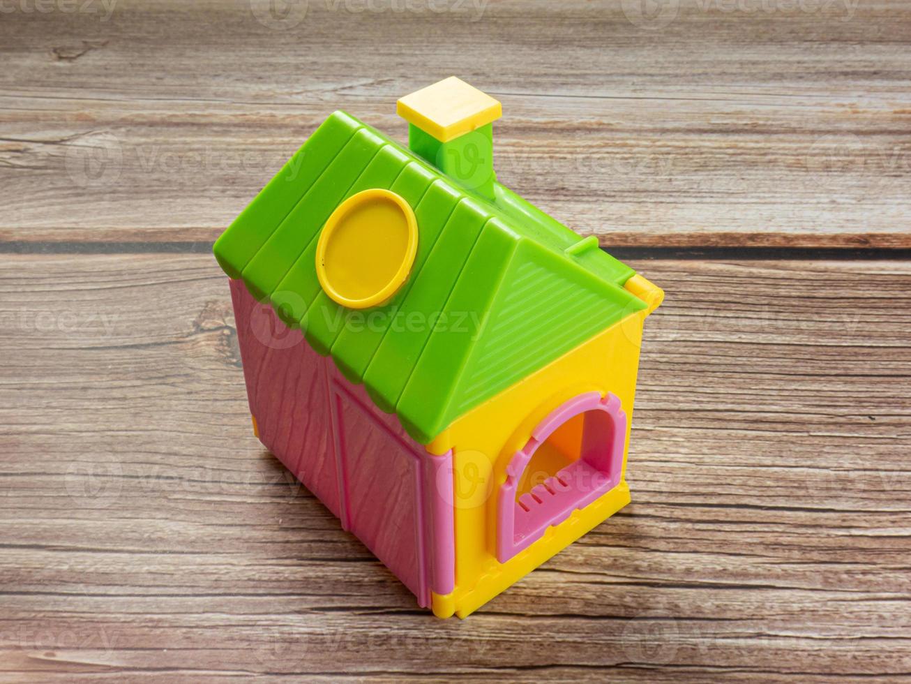 Home toy on wood  table for property or real estate  business concept photo