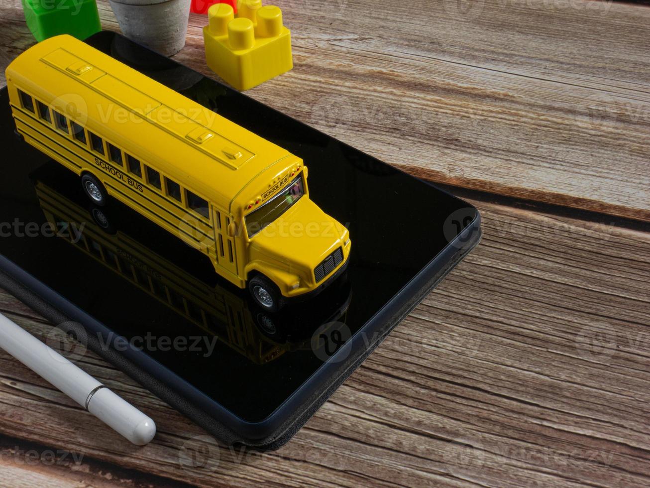 school bus on tablet for education or e learning concept photo