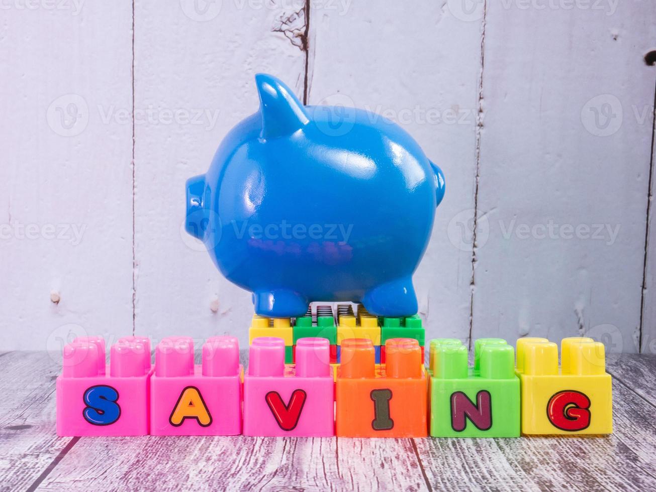 blue piggy bank on wood table for business concept photo