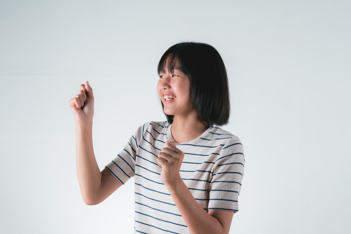 An Asian girl is showing a happy expression. photo