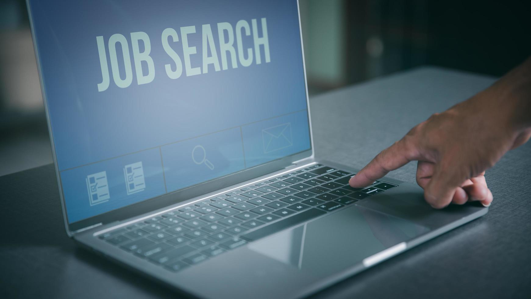 Searching for jobs and employment with online networking technology, recruiting careers and jobs from companies via the Internet, business people find information and new jobs through laptops. photo