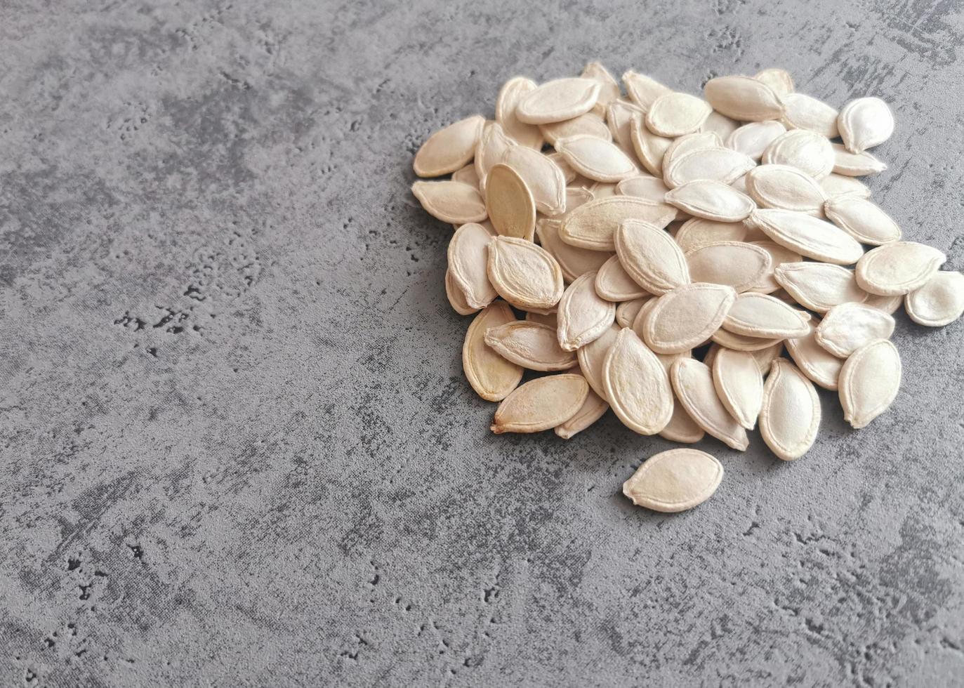 Close-up of white and whole pumpkin seeds photo