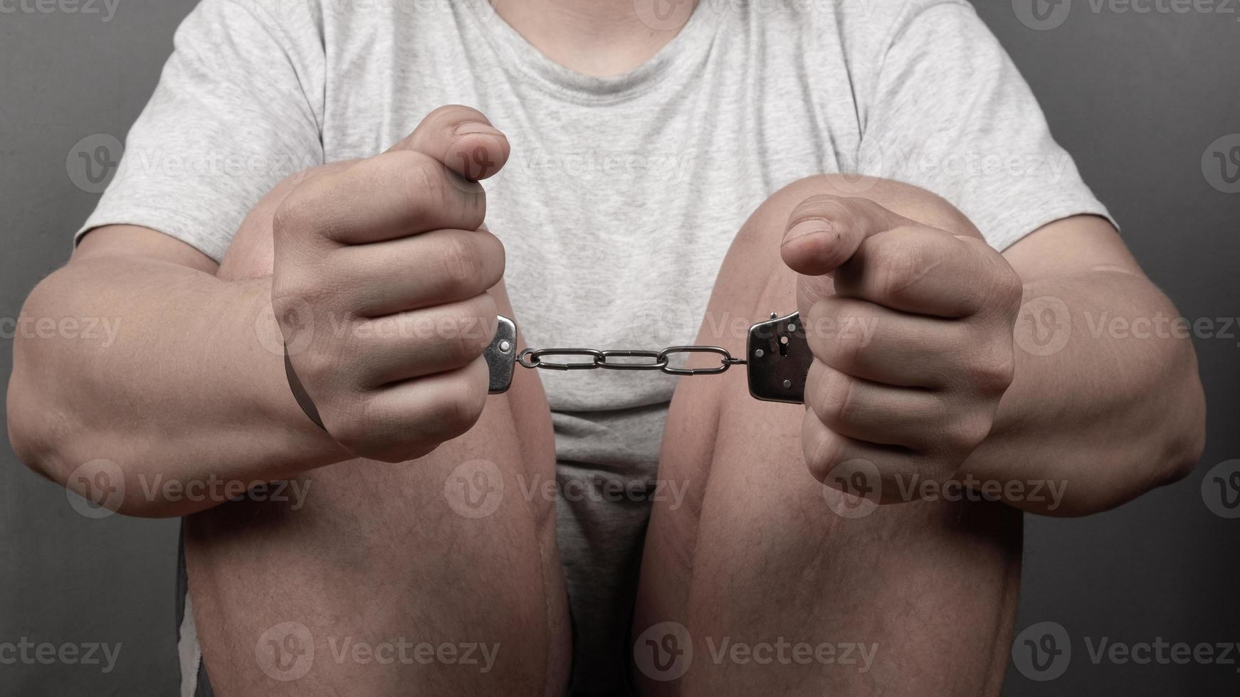 hands of a man in handcuffs, punishment for a crime criminal record photo