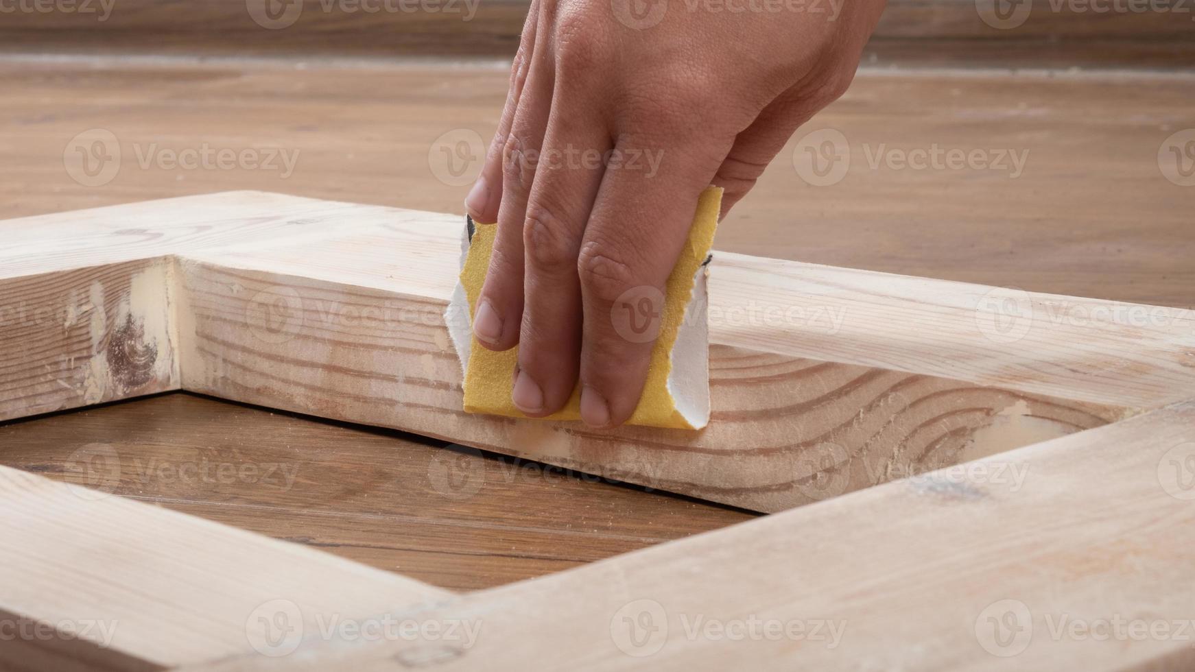 manual sanding of wooden doors with sandpaper photo