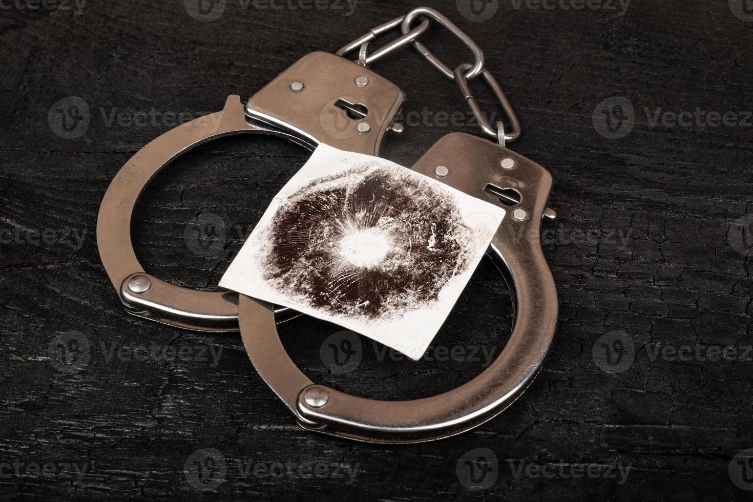 punishment for hallucinogenic mushrooms, handcuffs and mushroom print photo