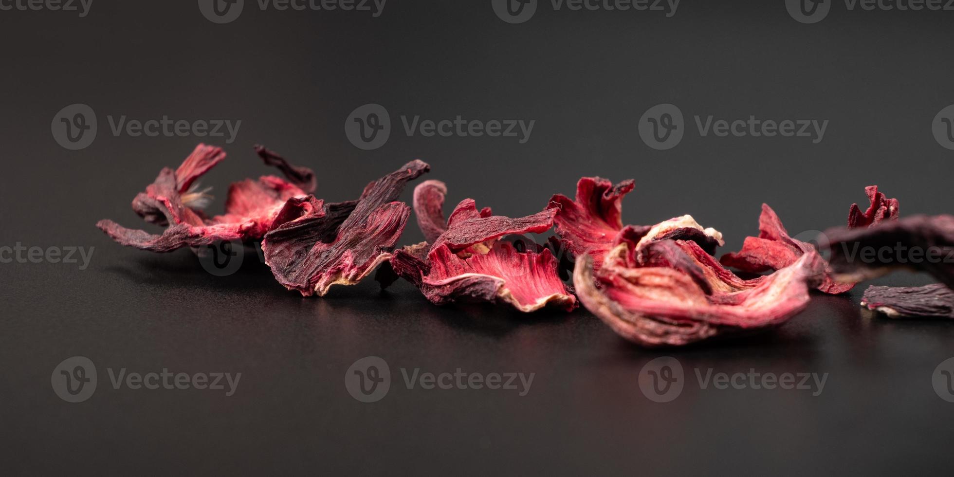 dried hibiscus tea petals on a dark background macro closeup photo