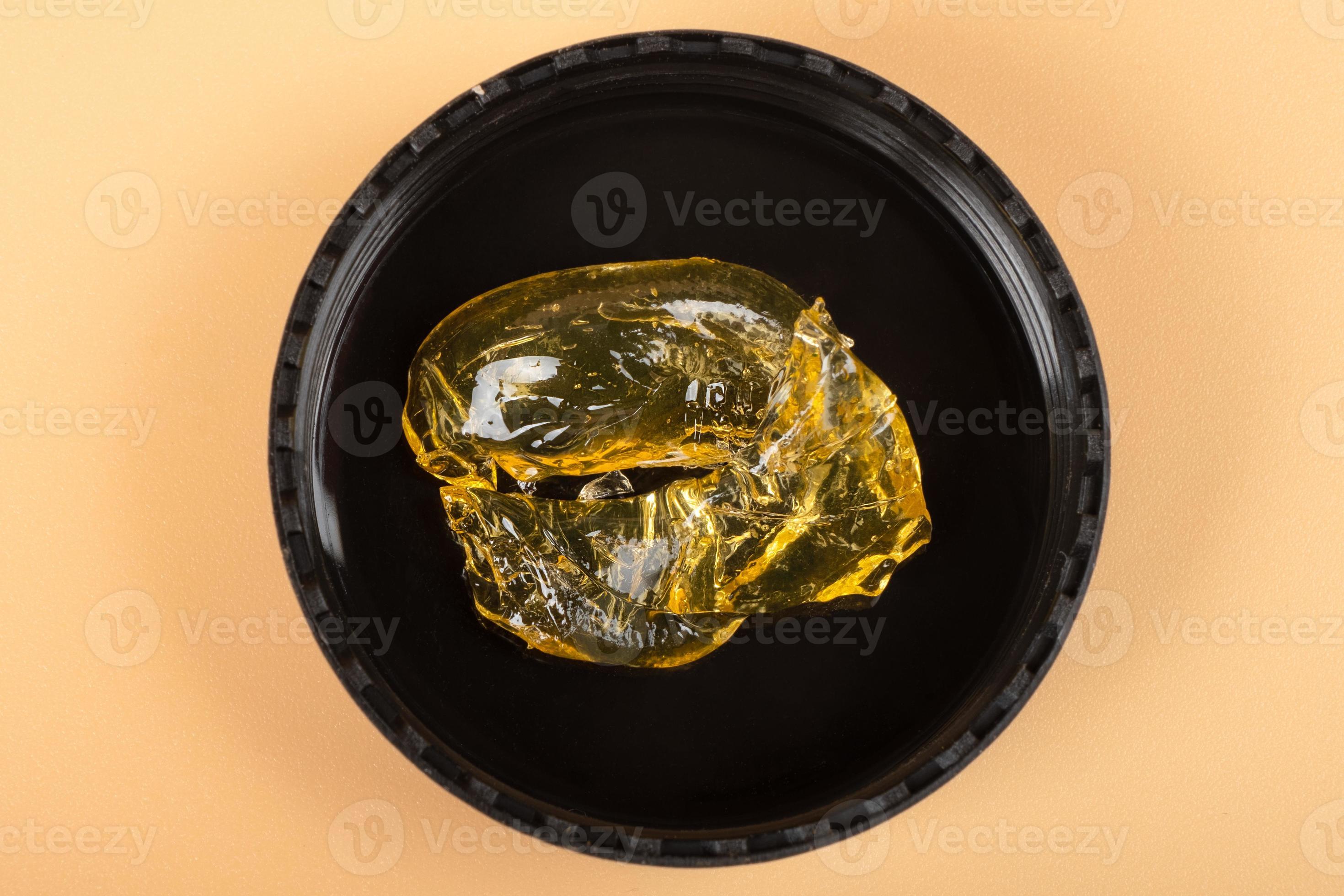 golden cannabis wax in a glass container, high thc dab in glass bottle 10140696 Stock Photo at