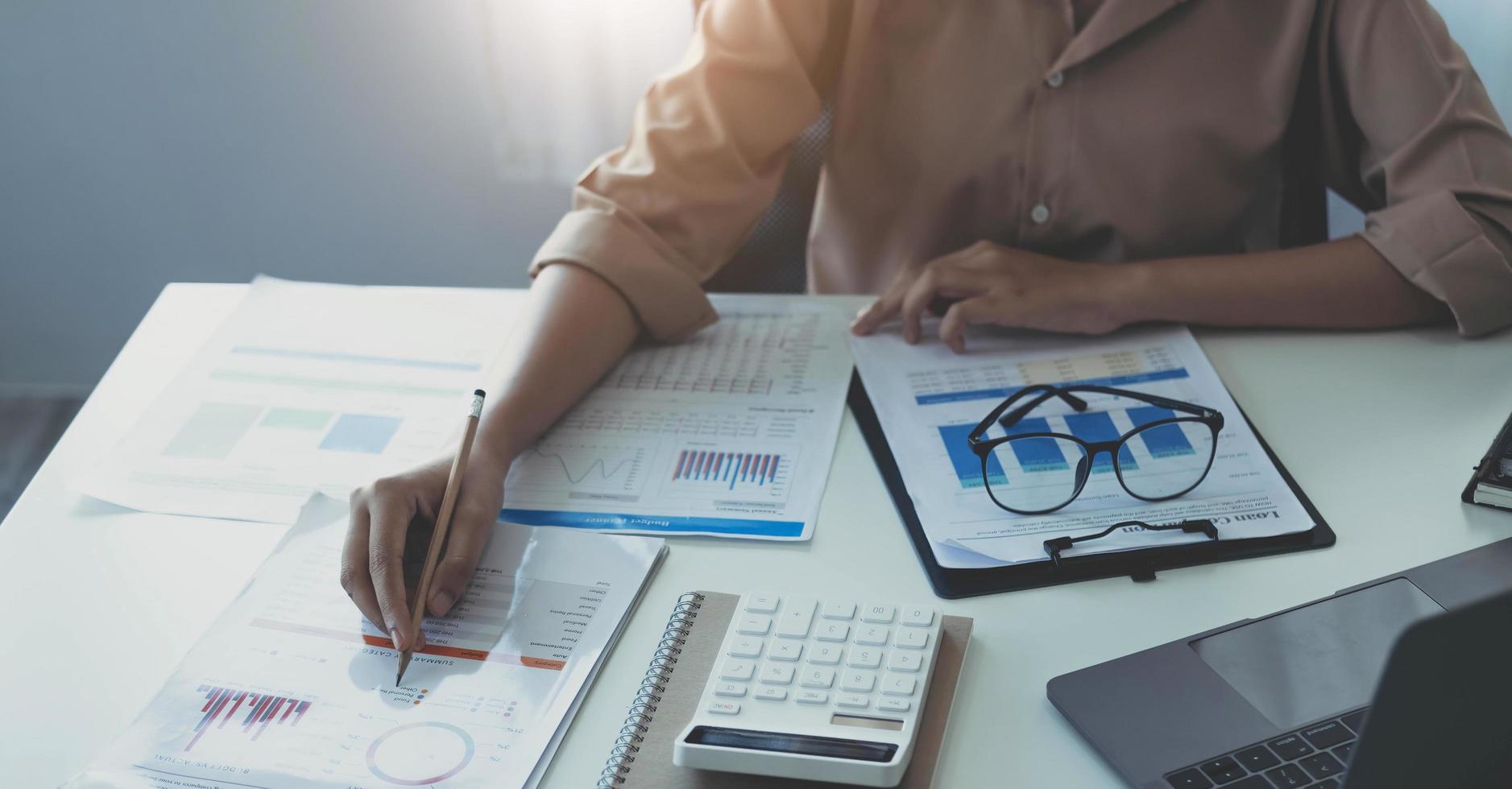 Business woman working to analyze technical price graph and indicator. photo