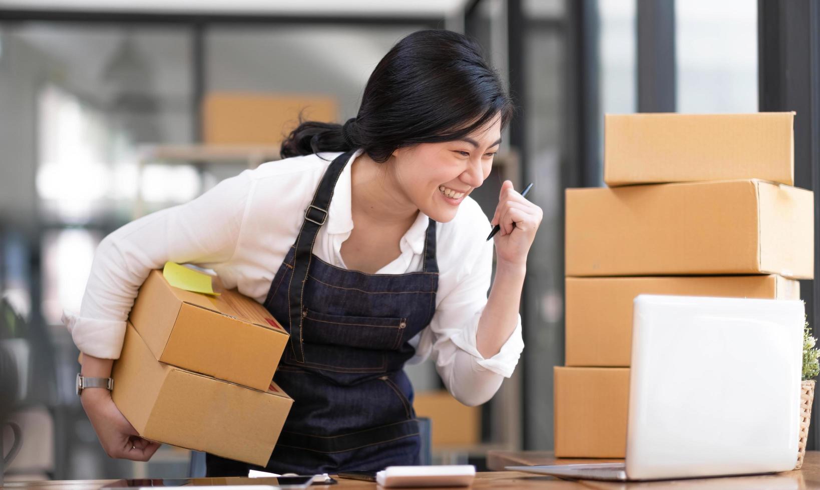 Portrait of Starting small businesses SME owners female entrepreneurs working on receipt box and check online orders to prepare to pack the boxes, sell to customers, SME business ideas online. photo