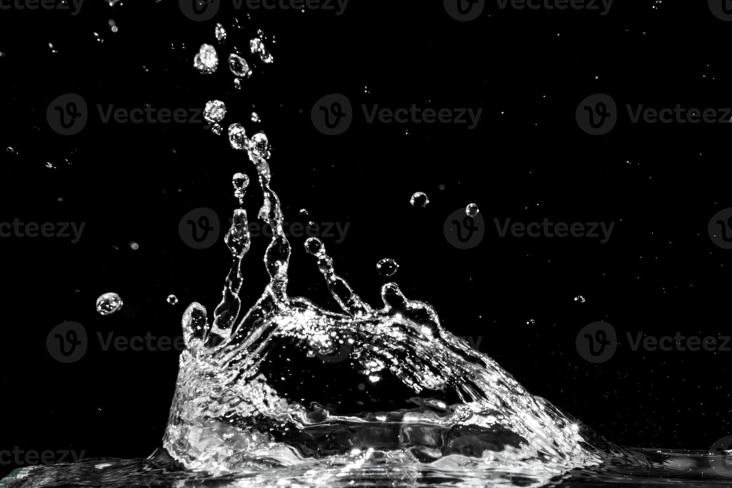 Water splash isolated on black background photo