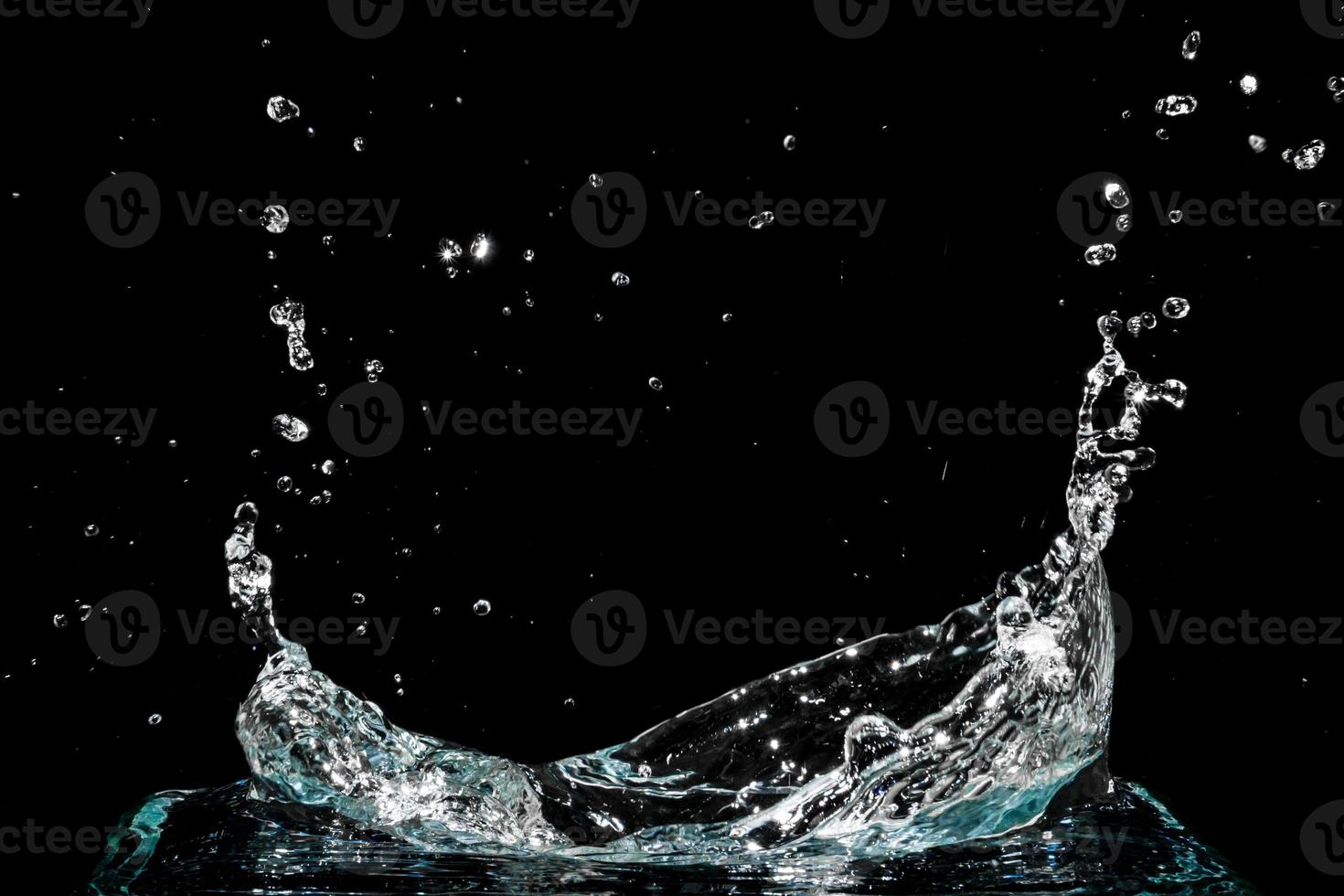 Water splash isolated on black background photo