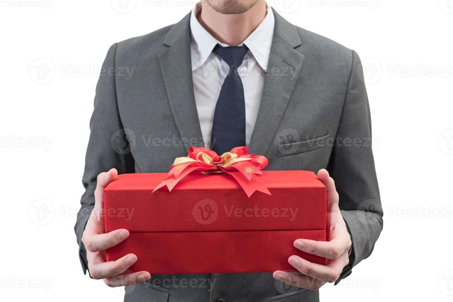 Businessman holding a red giftbox  isolated on white background. photo