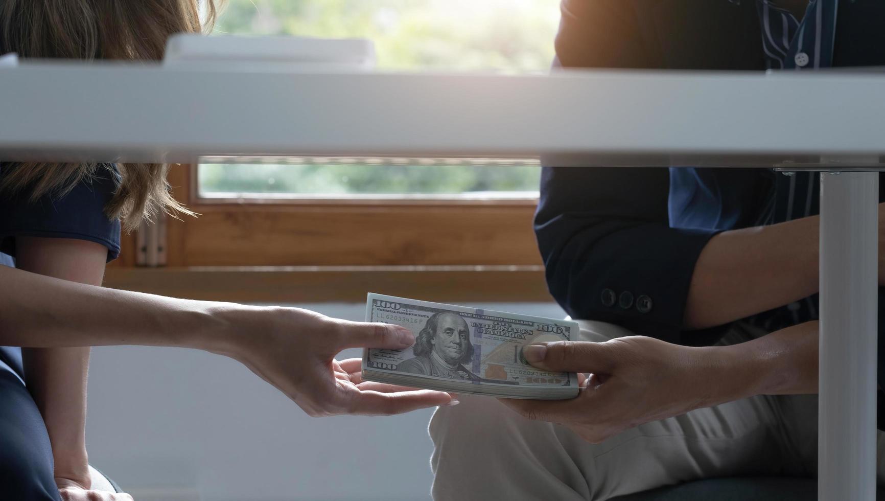 Partner give bribe money in envelope to another businessman. Corruption and Anti Bribery concepts. photo