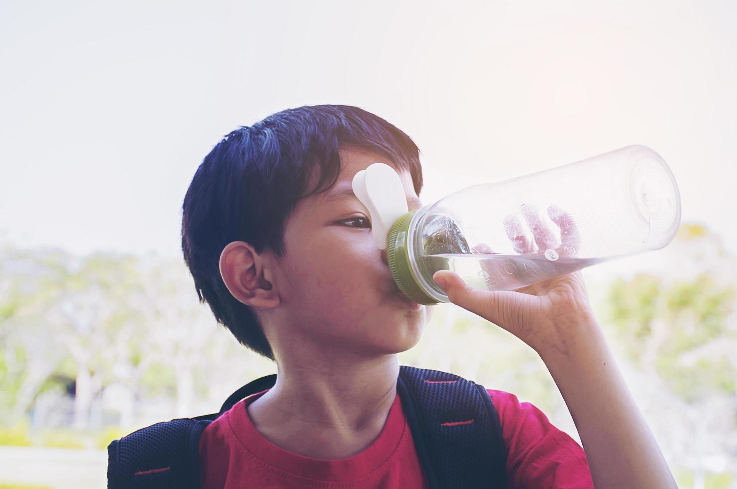 Boy drinking water photo