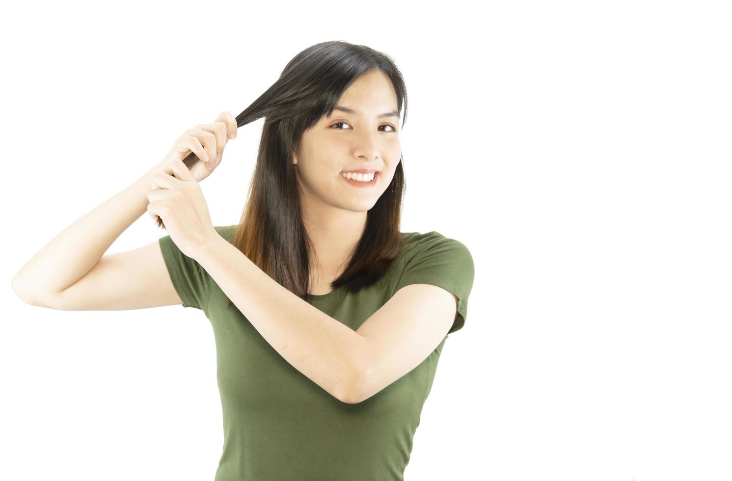 Beauty woman take care her hair using hair stretcher isolated over white background - people with hair care concept photo