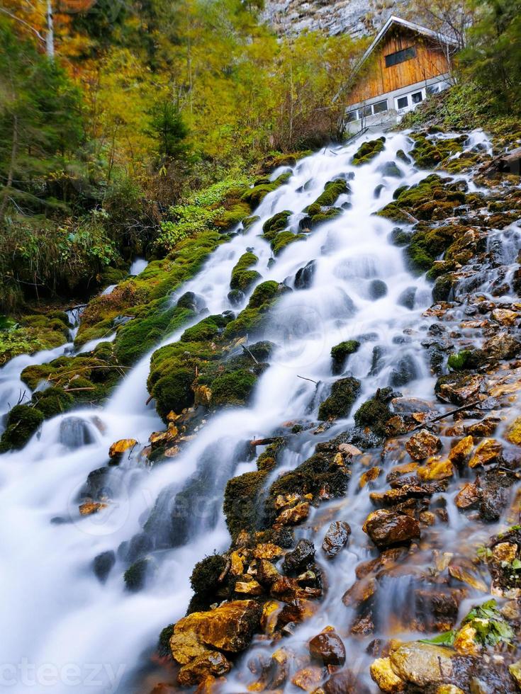 Beautiful waterfall flowing in the water. The river flows photo