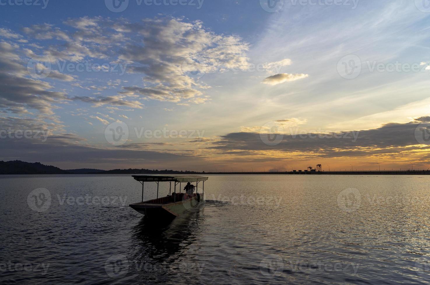 Passenger boats across the side of the dam. Evening atmosphere along the water in the dam photo