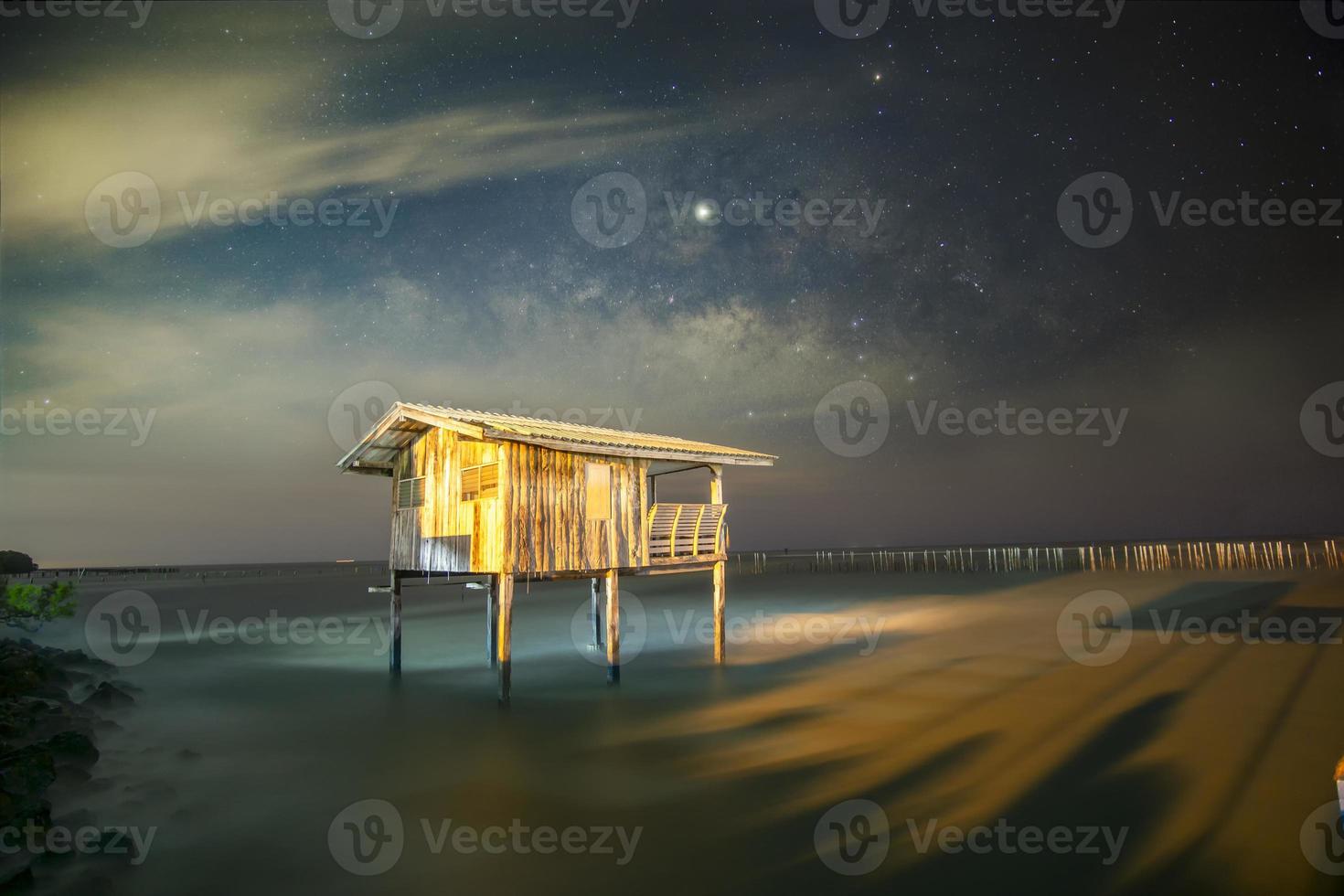 Old wooden house, no longer living in the sea, no way up the house Taken with the Milky Way as the back ground photo