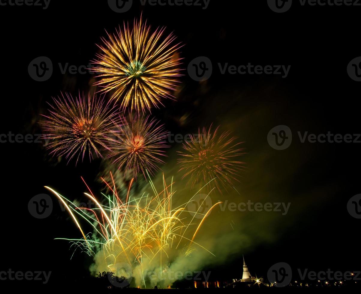 Huge, colorful fireworks over the rice fields at dusk. photo