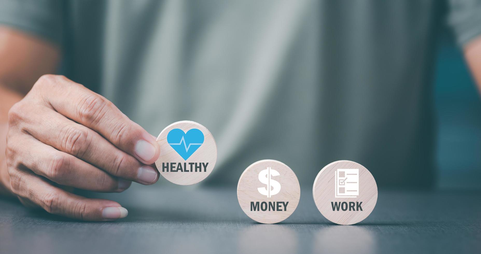 man holding a wooden block and showing a message Concept of focusing on health care, before work and money matters, photo