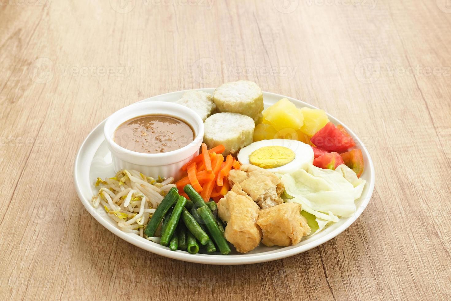 Gado Gado, Indonesian traditional vegetable salad with peanut sauce, rice cake, tofu and egg photo