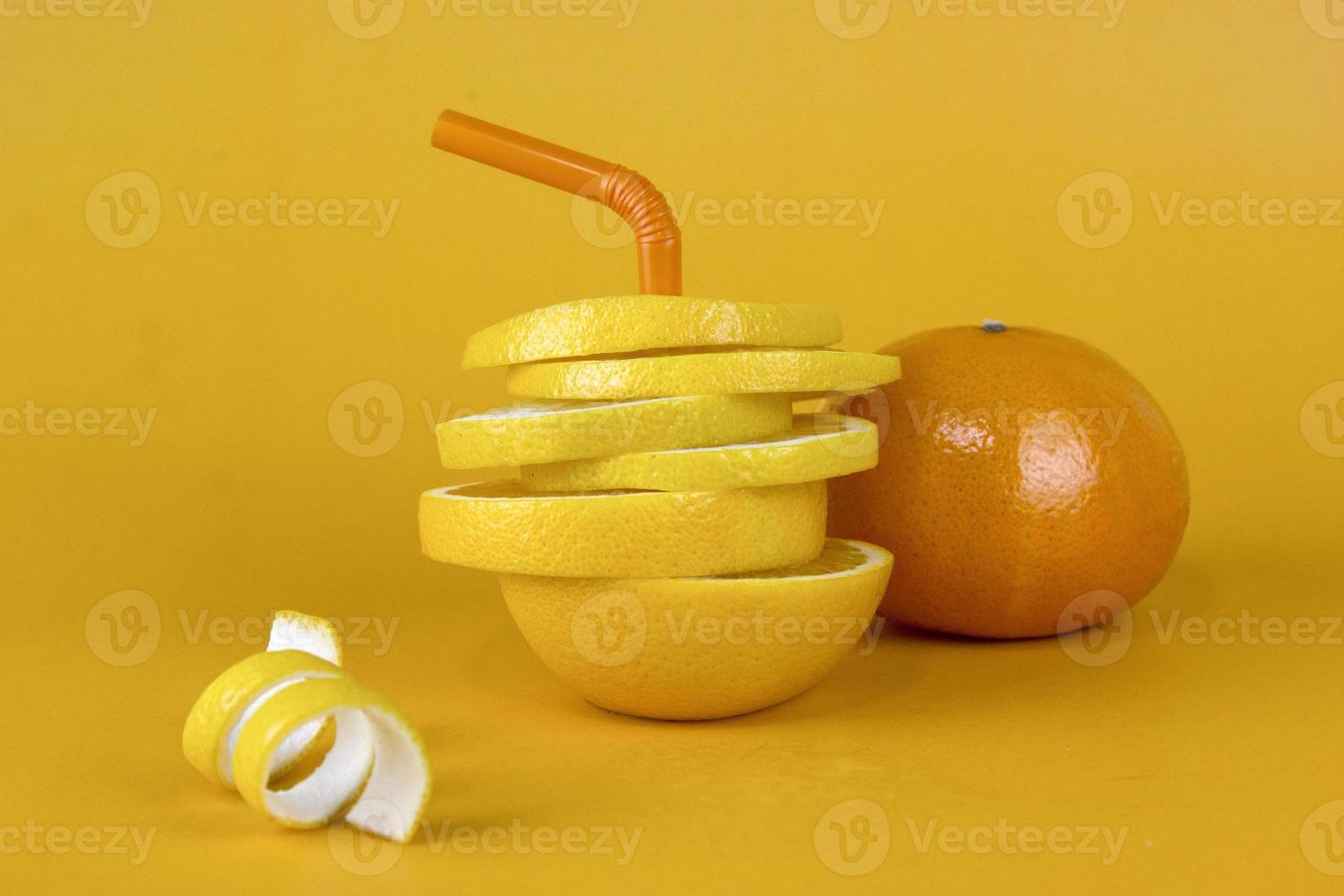 Lemon fruit slice in layers with peels and juicy orange isolated on yellow background. Juicy lemon sliced for fruits advertising design photo