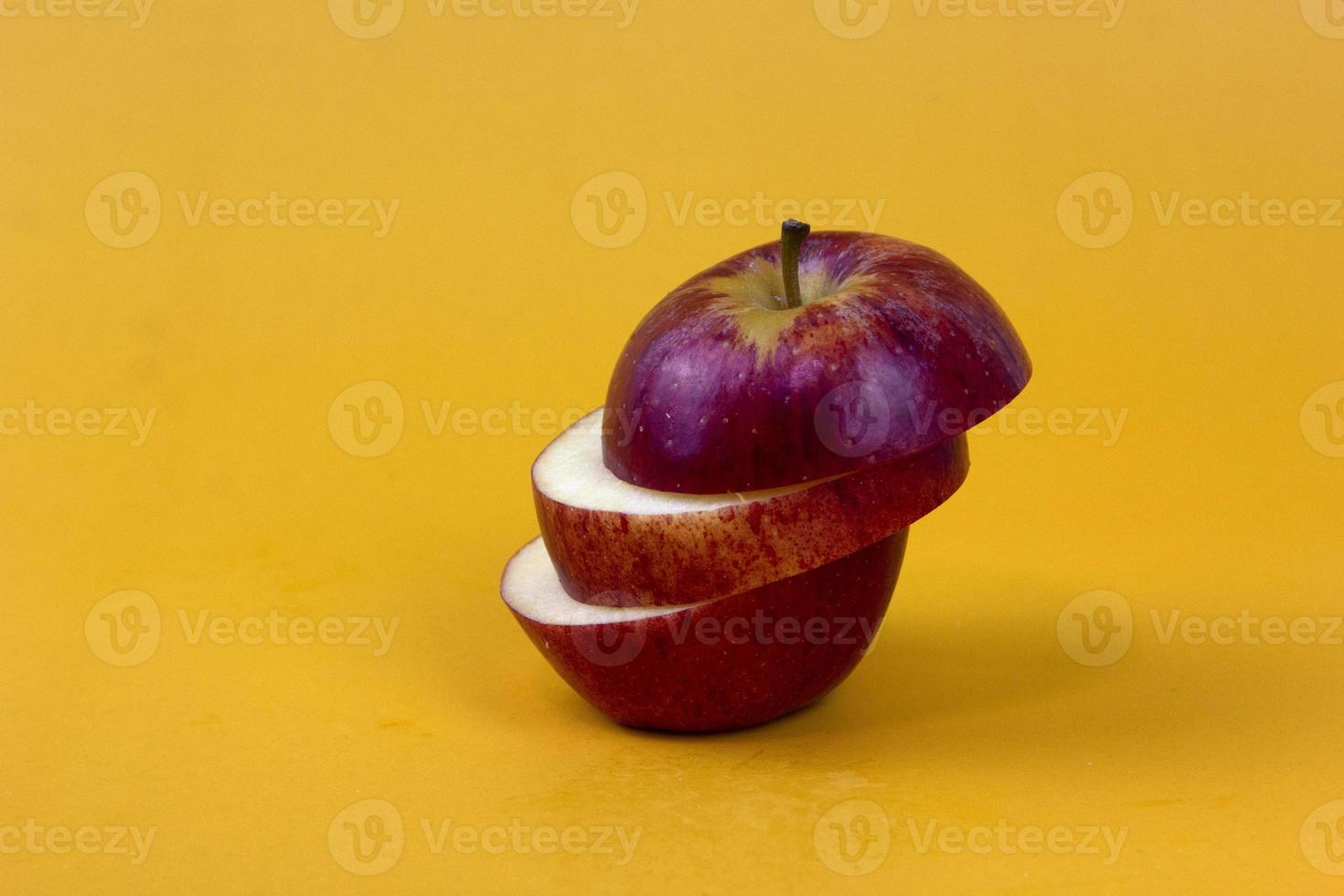Sliced apple isolated on yellow background. New isolate style for Fruit concept design photo