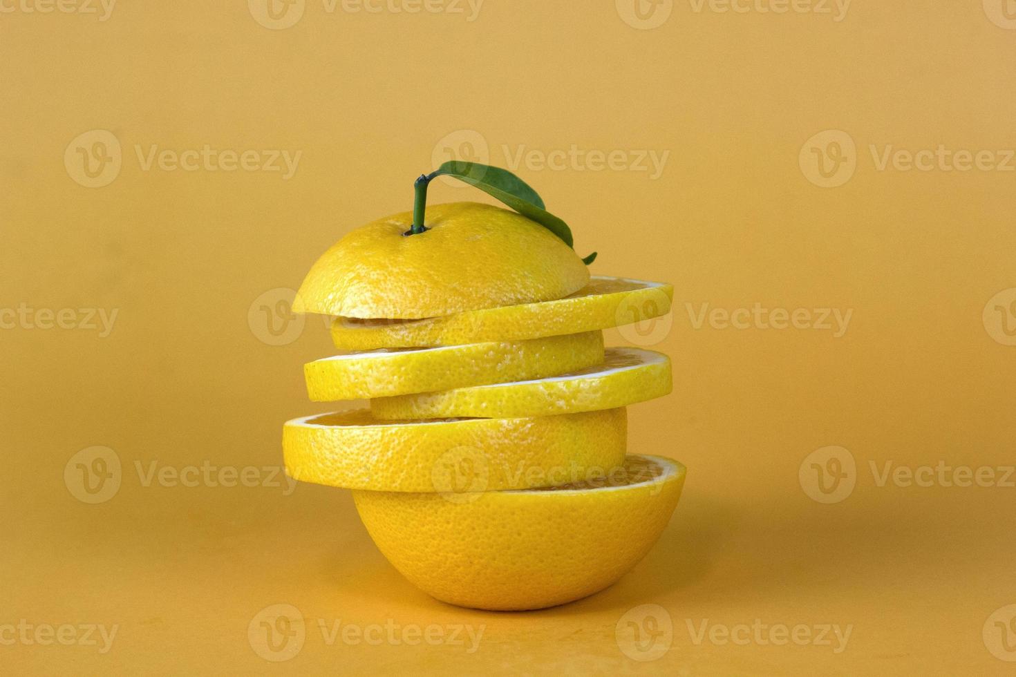 Lemon fruit slice in layers isolated on yellow background photo