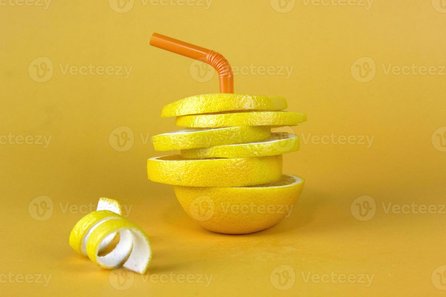 Lemon fruit slice in layers with peels isolated on yellow background. Juicy lemon sliced for fruits advertising design photo