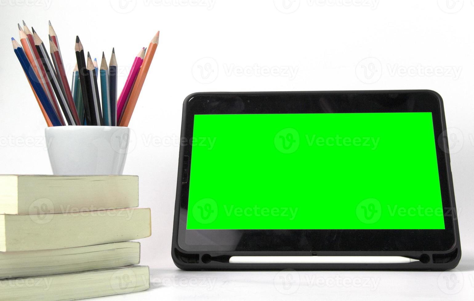 Education materials in the box, with ipad green screen and books isolated on white background. Back to school poaster concept templates photo