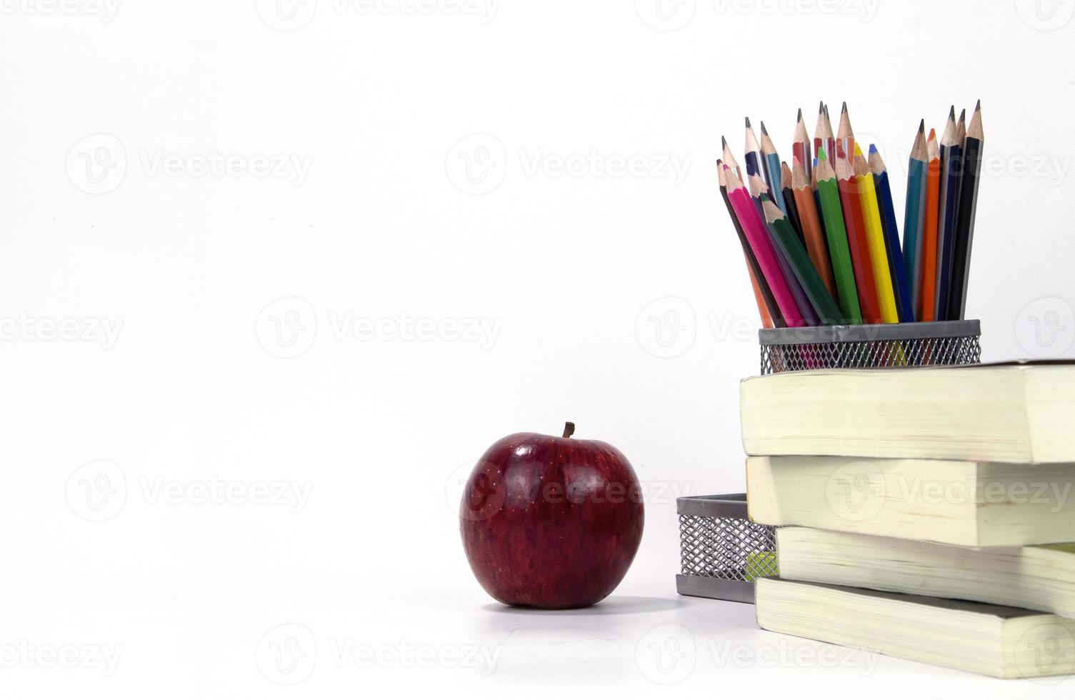 Education elements in the box with red apple and books isolated on white background. Back to school concept templates design photo