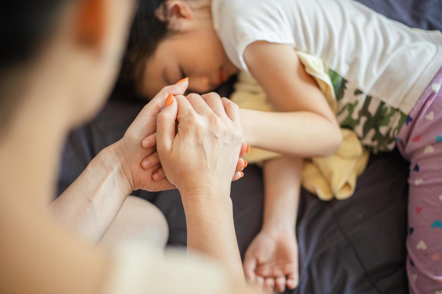 Mother taking care of sick daughter, health concept. photo