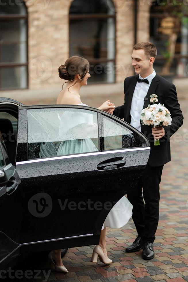young couple bride and groom in a white short dress photo