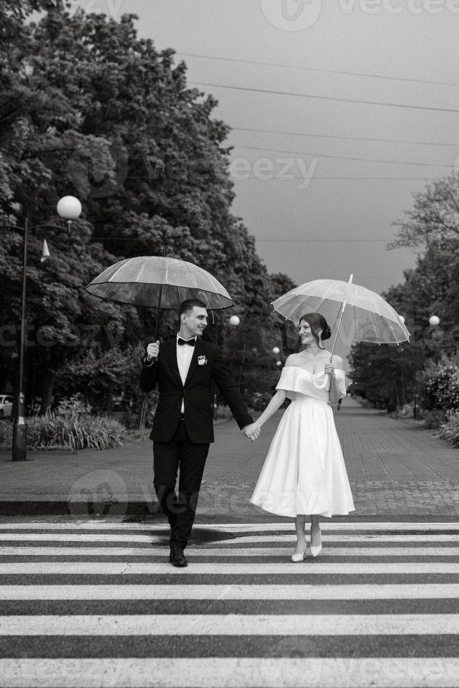 young couple bride and groom in a white short dress photo