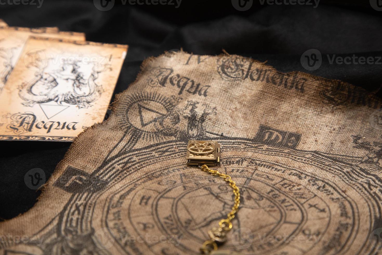 Ancient esoteric witchcraft background. Occultims and paganism old symbol, with mysterious runes alphabet photo